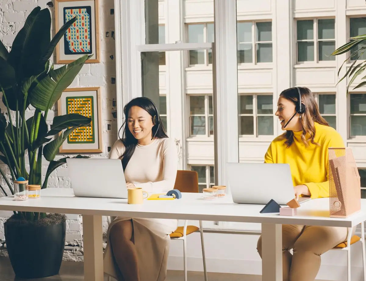 A customer support team member at a desk with a headset
