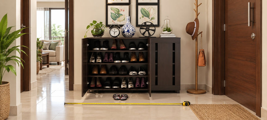 Minimal three-door shoe cabinet in a narrow entryway with a measuring tape on the floor